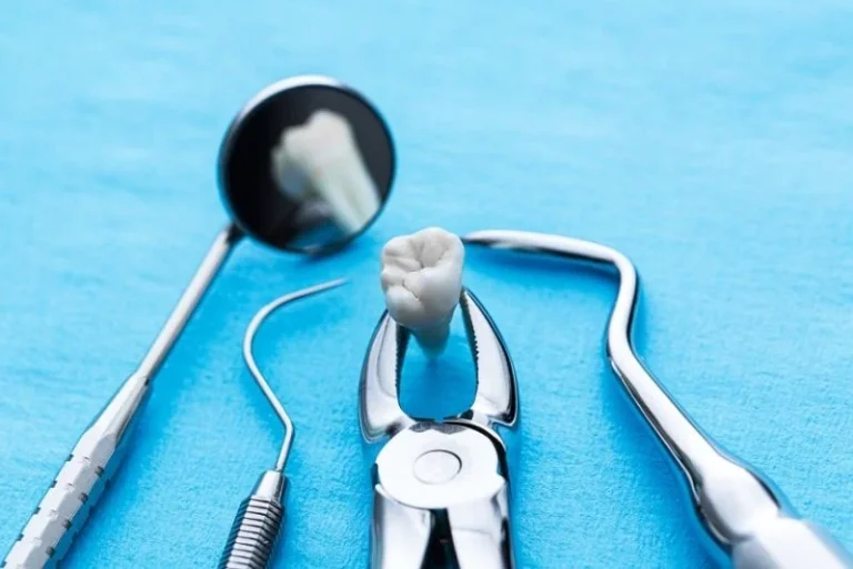 dental-tools-and-a-tooth-on-a-blue-surface